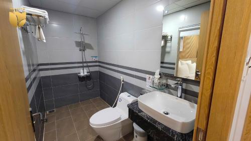 a bathroom with a white toilet and a sink at Rosetta Hotel Phu Quoc in Phu Quoc