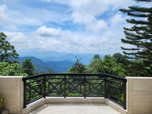 a balcony with a view of the mountains at Little England B5 - Fraser Panorama in Bukit Fraser
