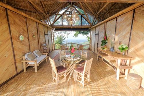 a room with a table and chairs in a house at Laputa Bali in Sidemen