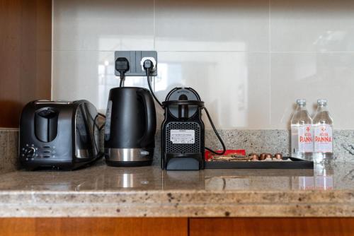 a kitchen counter with a toaster and a tea kettle at Downtown,Fountain view, nearBurj Khalifa,3 minutes walk to Dubai Mall in Dubai