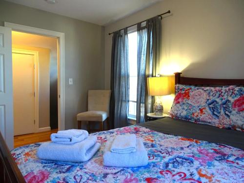 a bedroom with a bed with towels on it at Convenient 2 bed Apt in Everett a Short Walk to Encore in Everett