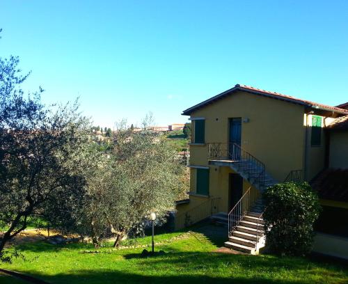 a house with a staircase leading up to it at Residence Le Meridiane in Siena