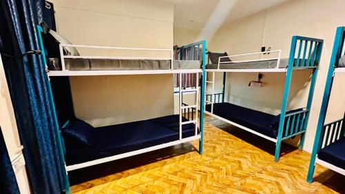 two bunk beds in a room with blue and white at Garden Aroma Palolem, Beachside Hostel & Cafe Bar in Palolem