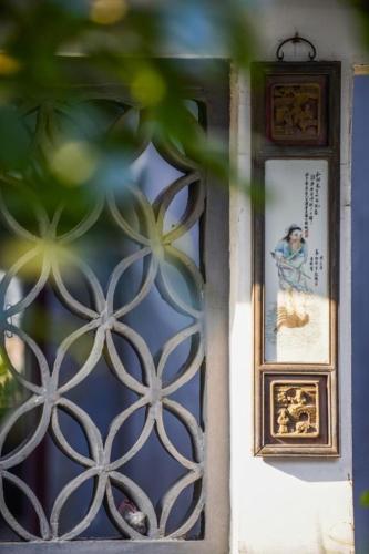 a door with a picture and a picture on it at Nanxun Luohua Old House Inn in Huzhou