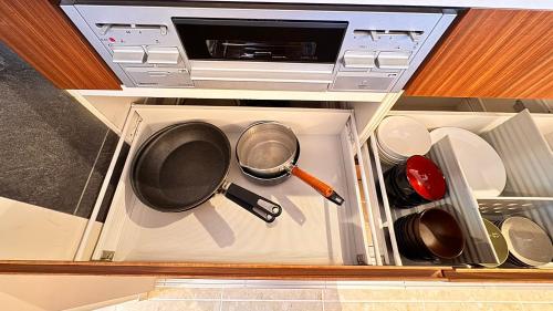 an open kitchen drawer with pots and pans at Sweet Villa OHJIMA in Ō-jima