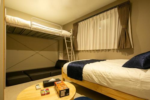 a bedroom with a bunk bed and a table at 藍-Ai-ASAKUSA in Tokyo