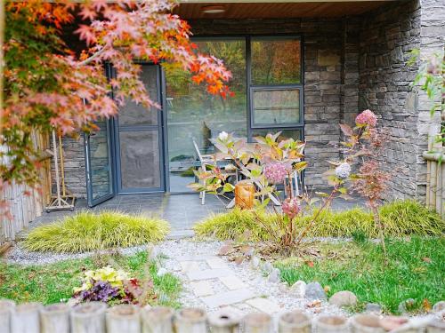 a front door of a house with a garden at Summergarden Hotel in Wolongguan