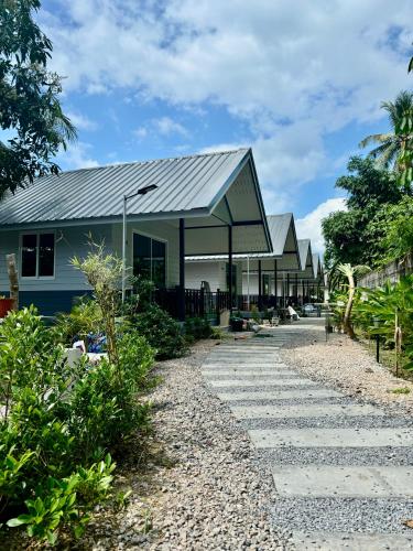 a building with a walkway in front of it at The Bay Koh Mook in Trang