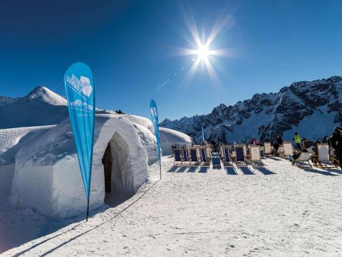 a snow covered building with blue signs in the snow at Chalet Nase at 1700m in the Zillertal in Grün