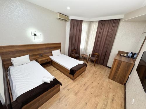 Postel nebo postele na pokoji v ubytování Consul Hotel