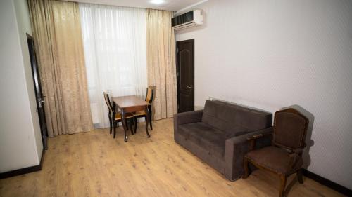 a living room with a couch and a table at Consul Hotel in Baku