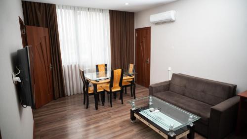 a living room with a couch and a table at Consul Hotel in Baku