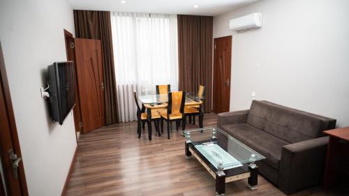 a living room with a couch and a table at Consul Hotel in Baku