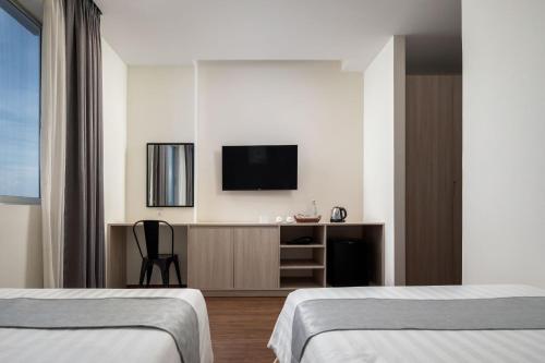 Ένα ή περισσότερα κρεβάτια σε δωμάτιο στο Joli Hotel