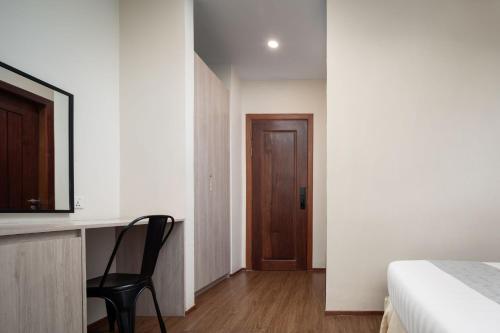 Ένα ή περισσότερα κρεβάτια σε δωμάτιο στο Joli Hotel