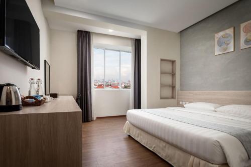 Ένα ή περισσότερα κρεβάτια σε δωμάτιο στο Joli Hotel