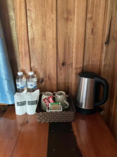 a tray with two bottles of water and a coffee maker at Kohjum Freedom Resort in Ko Jum
