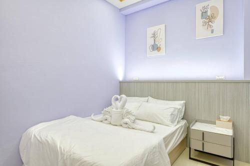 a bedroom with a bed with a stuffed bunny on it at Shijianhai B&B in Magong