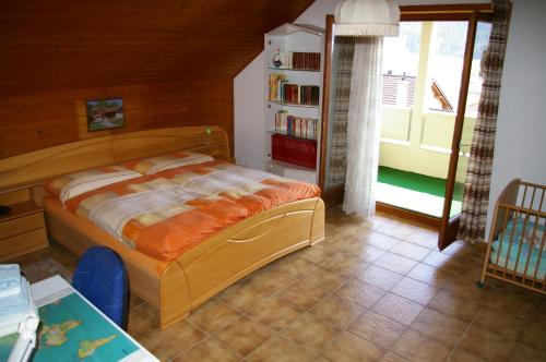 a bedroom with a bed and a book shelf at BnB Villa Moncalme in Travers