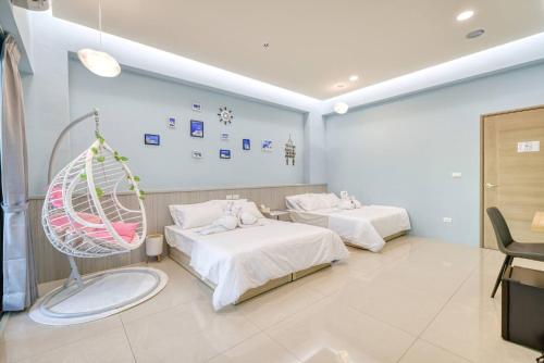 a hospital room with two beds and a swing at Shijianhai B&B in Magong