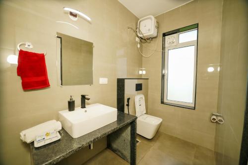 a bathroom with a sink and a toilet at Casa Das Imras Villa B in Calangute