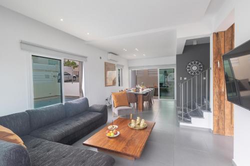 a living room with a couch and a table at Casa de Nicole in Protaras