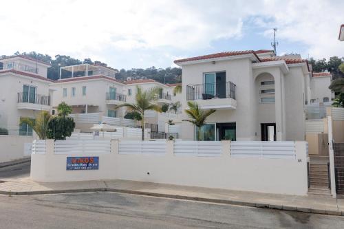 a large white house with a white fence at Casa de Nicole in Protaras