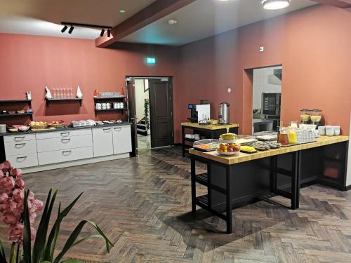 a large kitchen with a lot of food on tables at Hotel Parkzicht in Valkenburg