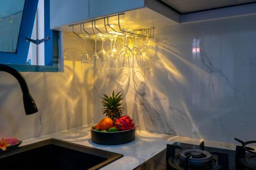 a kitchen with a bowl of fruit and a plant on a counter at Altea Villa Legian - 2BR Private Pool, Prime Location & Walk to Beach in Legian