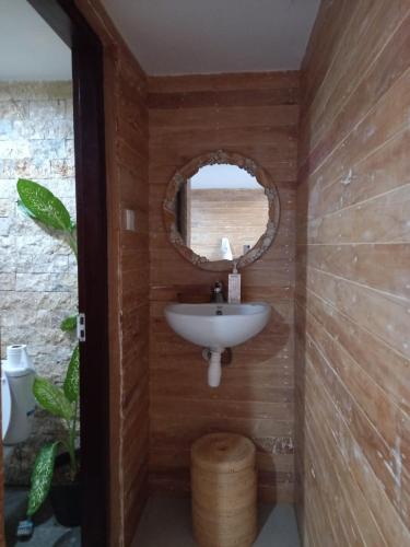 a bathroom with a sink and a mirror at VIP Homestay Lemukih in Singaraja