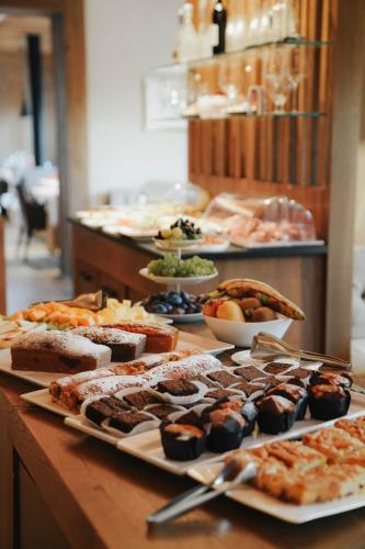 a buffet with several plates of food on a table at Hotel Restaurant Kirchsteiger in Vollan