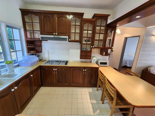 a kitchen with wooden cabinets and a counter top at Little England B8-3 in Bukit Fraser