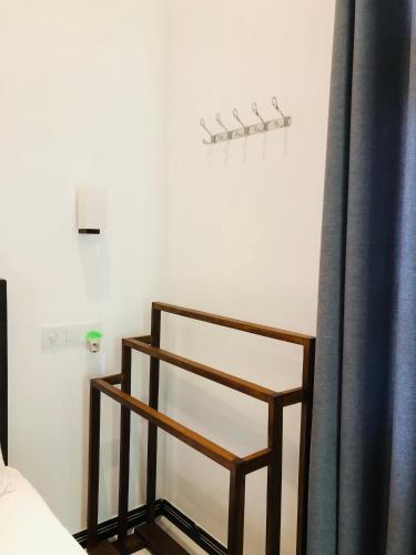 a chair in a room with a curtain at Devon Surf . Inn - Hiriketiya in Dickwella