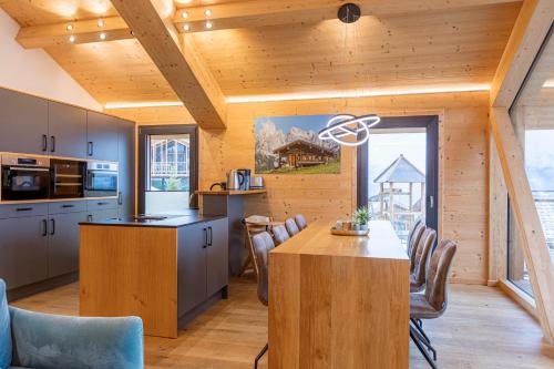 a kitchen and dining room with a table and chairs at Bergresort Hauser Kaibling by ALPS RESORTS in Haus im Ennstal