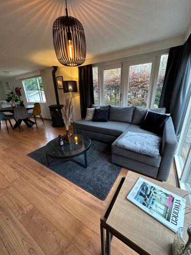 a living room with a couch and a table at Gezellig, mooi en ruim huisje in Baarle-Nassau in Baarle-Nassau