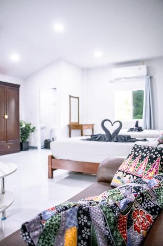 a bedroom with a bed and a couch in a room at Relax home in Ao Nang 