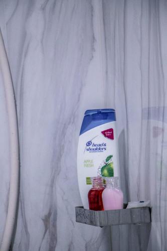 a shelf with a jug of milk and two bottles of liquid at Relax home in Ao Nang 