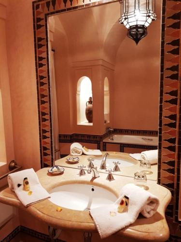 a bathroom with a sink and a large mirror at Private Villa at Jardins de Touhina in Marrakesh