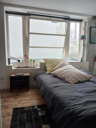 un lit dans une chambre avec une grande fenêtre dans l'établissement Stipologic 6P 2BR, à Paris