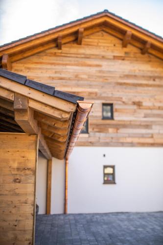 a wooden building with a gambrel roof at Apartment Wood&Stone Alpi in Garmisch-Partenkirchen