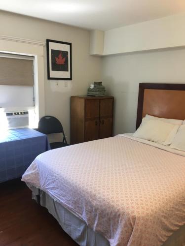 a bedroom with a bed and a dresser at Linda guesthouse in Vancouver