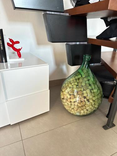 a large glass vase sitting on the floor in a room at Dimora Sant Anna in Piacenza