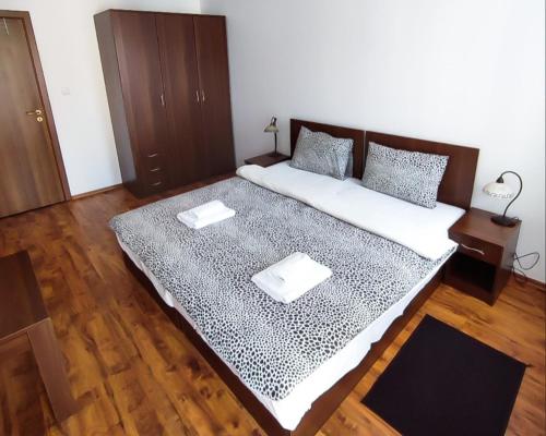 a large bed with two pillows on it in a room at "Mountain Dream" Apartments 200m from Ski Road in Bansko
