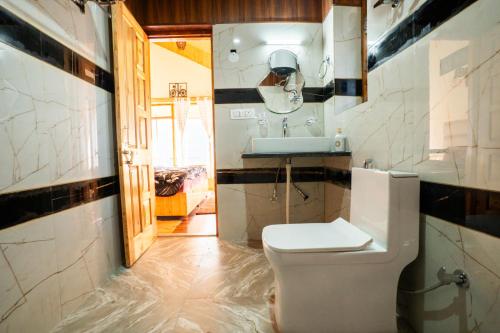 a bathroom with a toilet and a sink at Mellow- A Himalayan Home in Haripūr