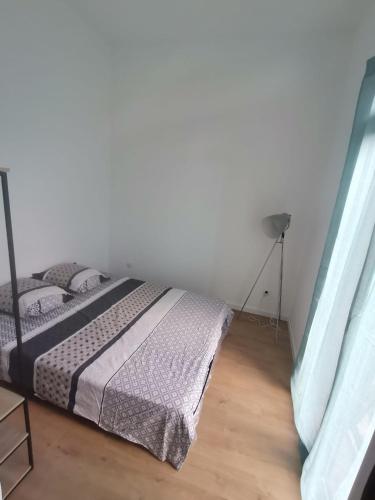 a bedroom with a bed in a white room at cardo village in Bastia