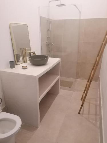 a bathroom with a sink and a glass shower at cardo village in Bastia