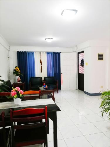 a living room with couches and a table and chairs at B Guest House Room Rentals in San Fernando
