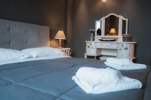 a bedroom with a large bed with a mirror at 2K Eco Villa in Plagiárion
