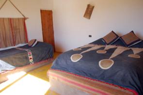 a bedroom with two beds in a room at Lodge Altitud in San Pedro de Atacama