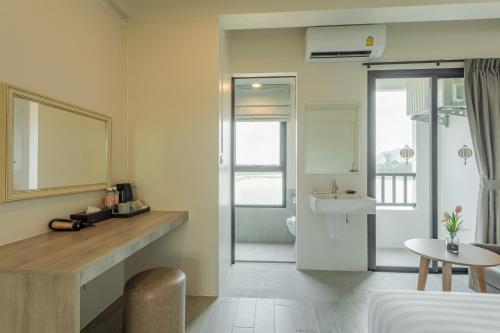 a hotel room with a bathroom and a sink at Ang Pao Hotel Phuket in Phuket Town